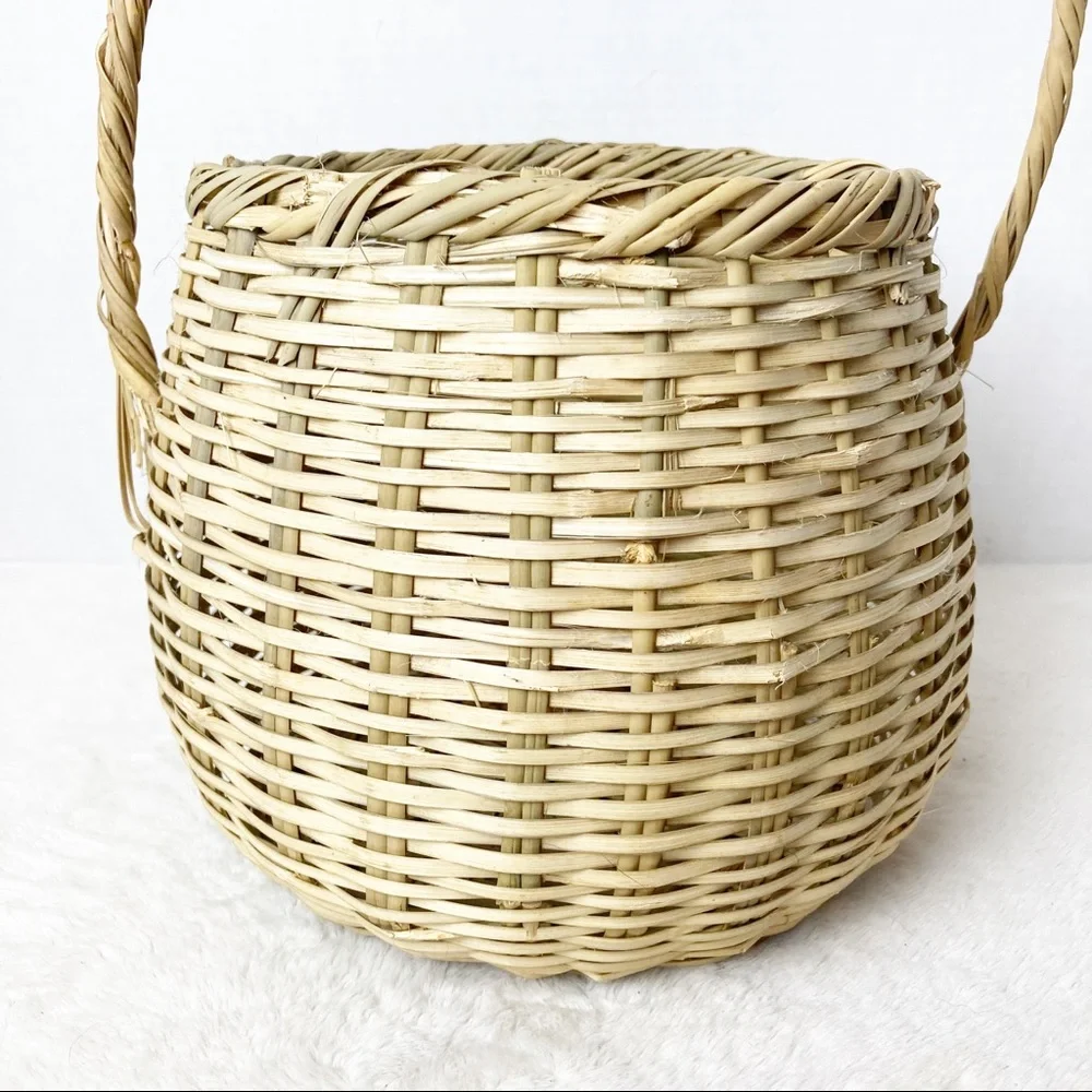 Handwoven deep wicker basket with tall handle